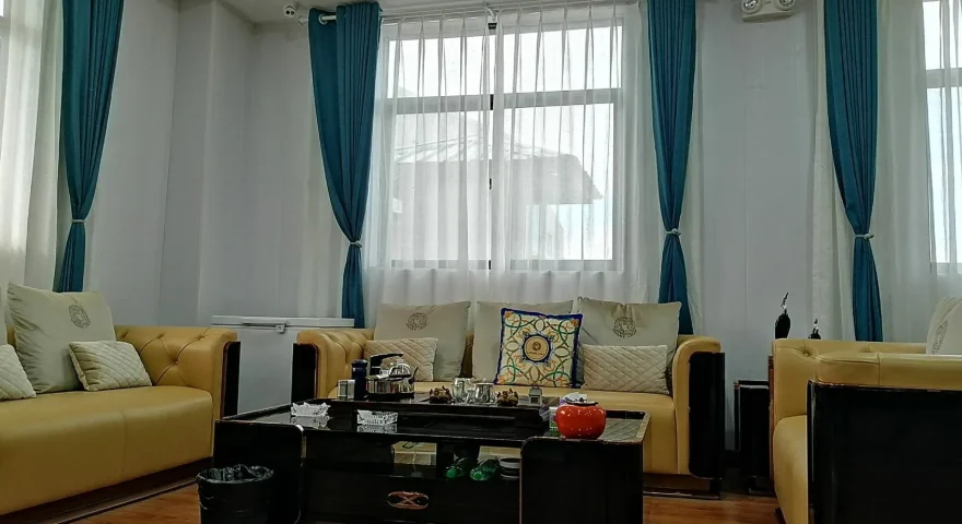 Living Room with White & Blue Curtains